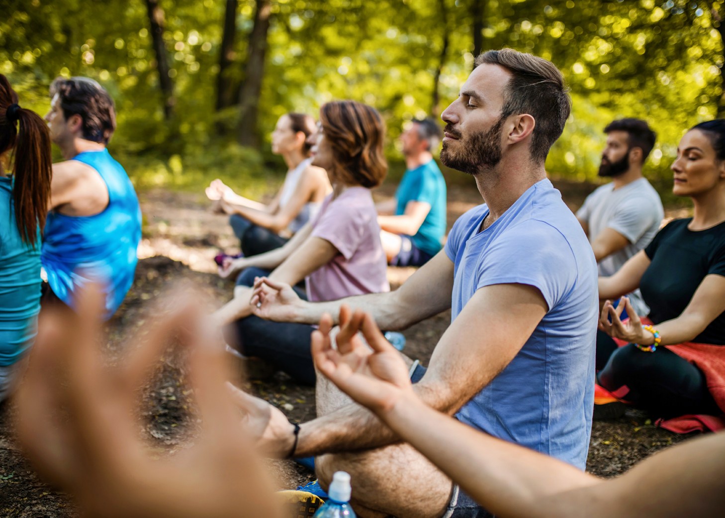 Grupo de personas haciendo yoga en el bosque.