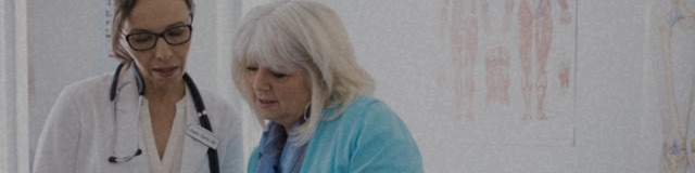 Older woman reviewing chart with female doctor.